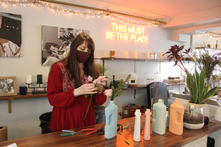 Janessa Stoltz, co-owner of Acorn &amp; the Oak, arranges flowers in the Camas-based flower shop and Midwest supper club-inspired restaurant on Friday, Jan. 21, 2022.