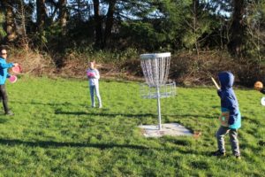 Washougal resident Stuart Mullenberg (far left) throws discs with his children, (left to right) Lily, 10; Finn, 8; and Felix, 5, at the Hartwood Park disc golf course on Jan. 27, 2022. (Doug Flanagan/Post-Record)