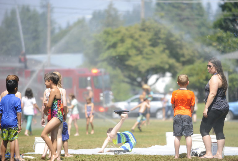 Children cool off at Crown Park on Aug. 11, 2017.