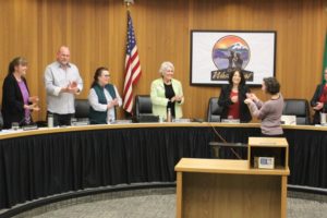 Doug Flanagan/Post-Record 
 Washougal city councilmembers applaud as Washougal Community Library manager Rachael Ries (second from right) receives a medal during a council meeting on Monday, March 14, at City Hall. (Doug Flanagan/Post-Record)