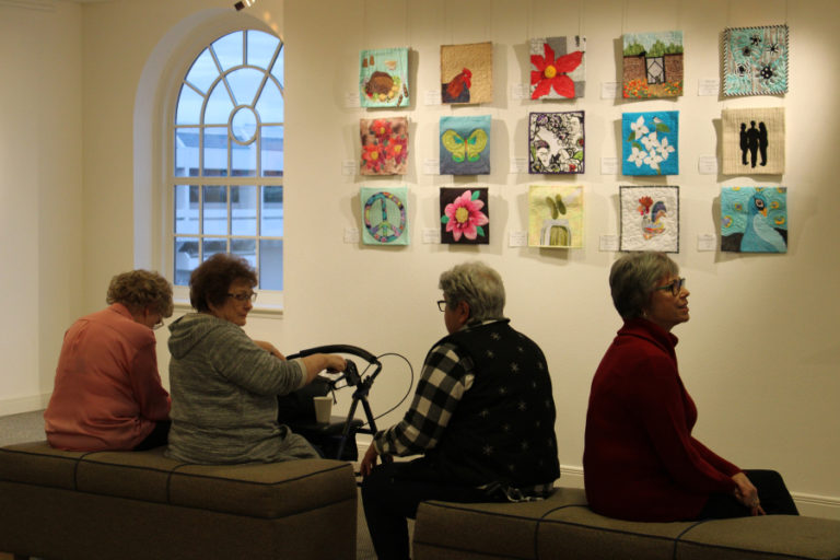 Visitors to the Second Story Gallery, located on the second floor of the Camas Public Library, sit near an art display on Dec. 6, 2019.