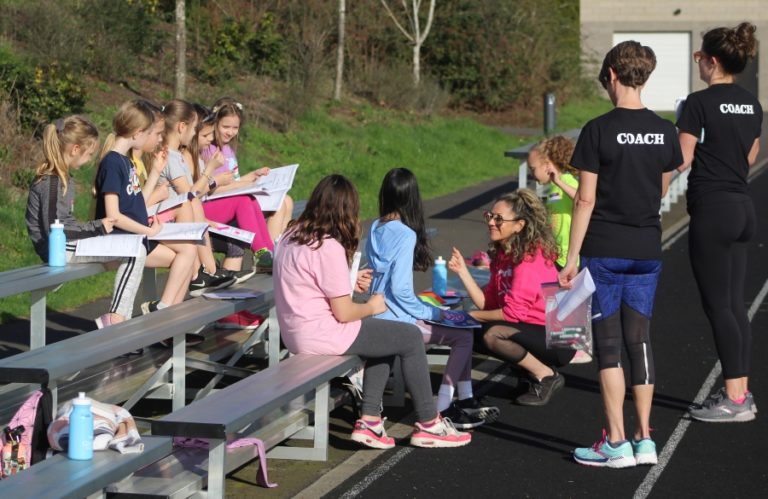 Doug Flanagan/Post-Record 
 Washougal Girls on the Run coach Lilia Grundy (pink shirt) talks to her team during a practice session on Thursday, March 24, at Columbia River Gorge Elementary School.