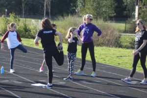 Washougal Girls on the Run coach Denise Wilson (second from right) leads her team in a warm-up exercise during a Washougal Girls on the Run practice at Columbia River Gorge Elementary School in Washougal on Wednesday, March 23, 2022. (Photos by Doug Flanagan/Post-Record)