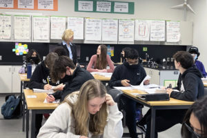 Washougal School District Superintendent Mary Templeton (standing) talks to an Issaquah School district student at Pine Lake Middle School in Sammamish, Wash., on Monday, March 21, 2022. (Contributed photo courtesy of the Issaquah School District)