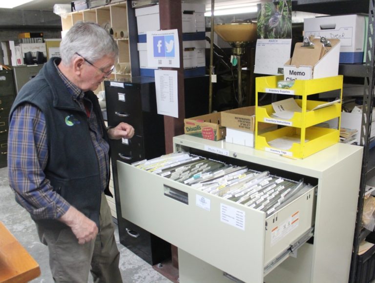 Camas-Washougal Historical Society board member Richard Johnson opens a file cabinet filled with old photographs at Two Rivers Heritage Museum in Washougal on Thursday, March 31, 2022. The museum is working with the Clark County Historical Museum and Washington State University-Vancouver to digitize its entire photograph collection.