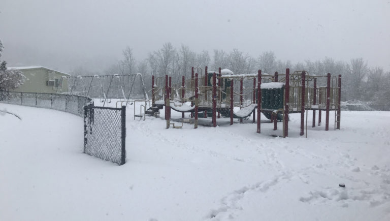 Snow falls on the playground at Grass Valley Elementary School in Camas on Monday, April 11, 2022.