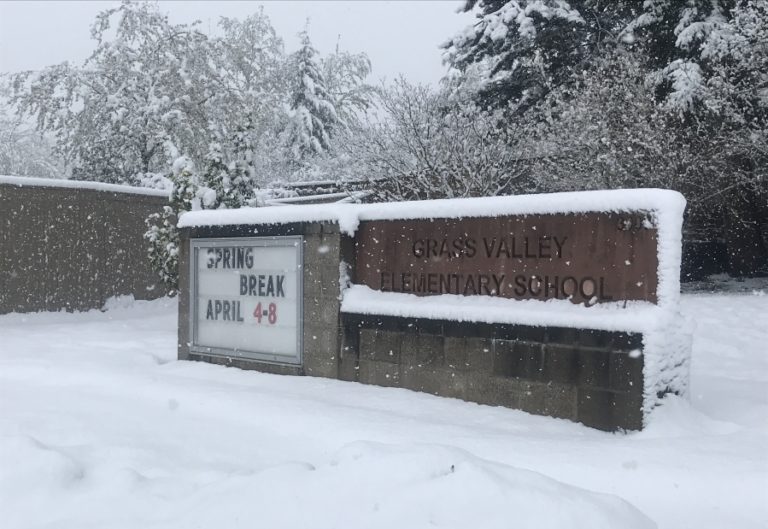 Snow falls on a sign announcing the dates of Camas School District&#039;s spring break outside Grass Valley Elementary School in Camas on Monday, April 11, 2022. District officials granted students an extra day of spring break, cancelling all classes and activities due to the snow.