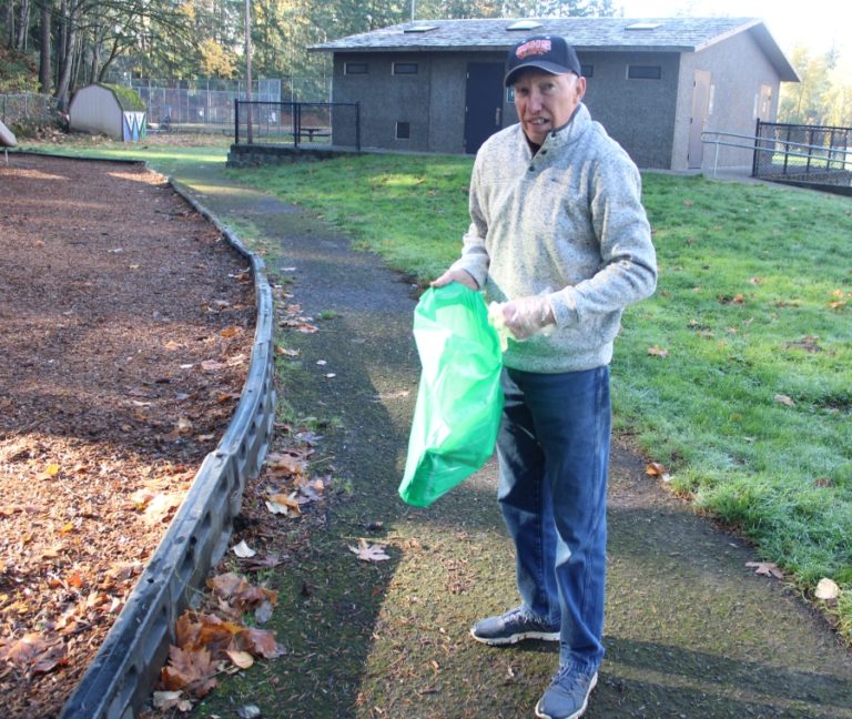 Doug Flanagan/Post-Record 
 Washougal resident Rod Tipton picks up garbage at Hathaway Park in Washougal in November 2021. The city of Washougal will hold its first Hello Spring Community Fair on Saturday, April 30, at the park. City leaders are encouraging people to pick up litter in their neighborhoods in the morning before coming to the event.