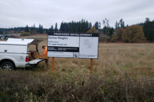 A "proposed development" sign, proposing a subdivision with 122 single-family homes, sits on a 37-acre parcel at 26630 N.E. 28th St., in north Camas, in 2021. (Contributed photo courtesy of the city of Camas)