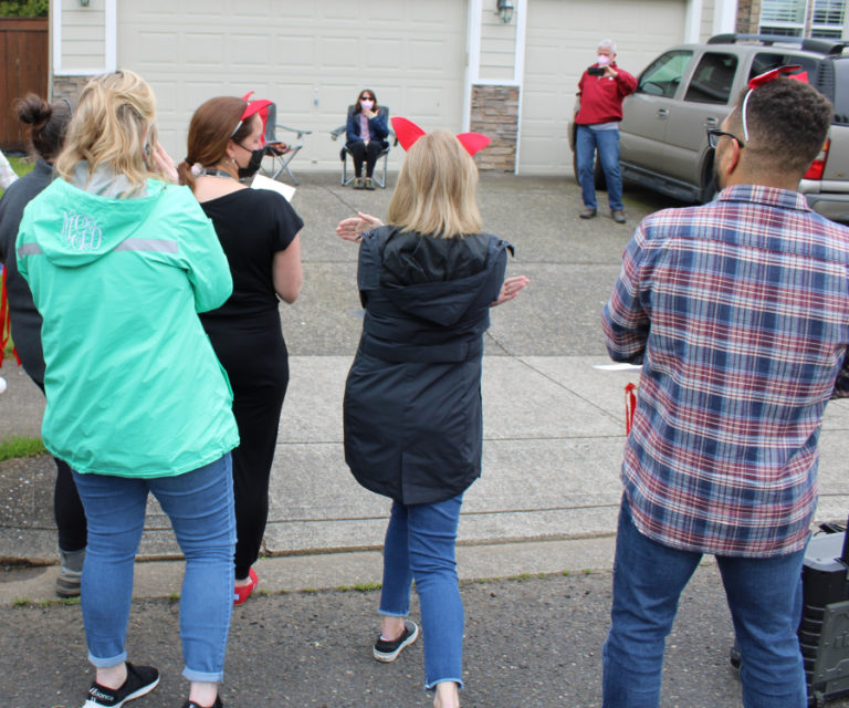 A crowd of well-wishers from Dorothy Fox Elementary School gathers in front of the Camas home of Julie Savelesky, a Dorothy Fox second-grade teacher recovering from cancer surgery, on Friday, May 13, 2022.