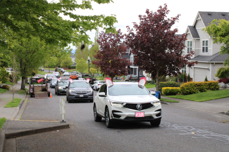 A parade of vehicles bearing the signature Dorothy Fox Elementary School &quot;fox ears&quot; drive through second-grade teacher Julie Savelesky&#039;s Camas neighborhood on Friday, May 13, 2022. The parade, organized by Dorothy Fox staff, was meant to cheer Savelesky, who underwent surgery for cancer in April.