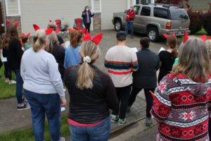 Dorothy Fox Elementary School staff and their family members wear the school's signature "fox ears," and gather in front of Julie Savelesky's Camas home on Friday, May 13, 2022. The staff members wanted to bring some joy to their coworker and friend while Savelesky (background, pink shirt), a second-grade Dorothy Fox teacher, recovers from cancer surgery. (Photos by Kelly Moyer/Post-Record)