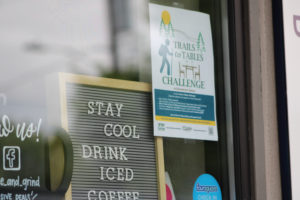 A Trails to Tables Challenge sign sits inside the Squeeze & Grind cafe in Camas in June 2021. (Kelly Moyer/Post-Record files) 