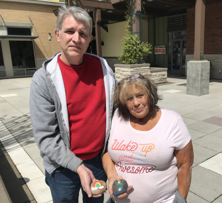 Washougal residents Rich Beck and Kathy Dering hold two of the rocks that will go into the Washougal Children&#039;s Rock Garden, the city&#039;s first interactive art installation created by children, on Saturday, May 14.