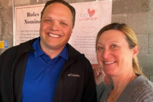 100 Women Who Care Clark County's advisory board president Megan Lutz (right) presents a donation to Dave Cole, executive director of Family Promise Clark County, during a 100 Women Who Care meeting at Salud! in downtown Camas on May 11, 2022. (Contributed photo courtesy of Sue Dockstader)