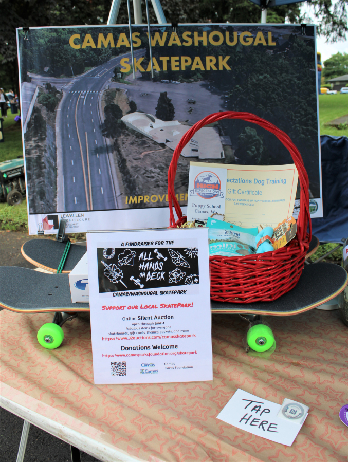 Items for a silent auction to benefit the Camas-Washougal Skate Park remodel sit at a booth at the Camtown Youth Festival at Crown Park in Camas, on Saturday, June 4, 2022.