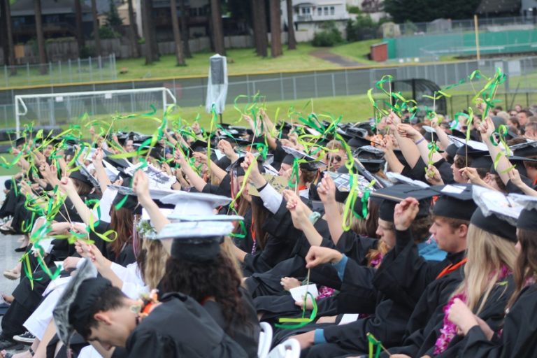 Doug Flanagan/Post-Record 
 Graduates wave ribbons in memory of classmate Zain Justis, who passed away in September 2021, during the Washougal High School class of 2022 commencement ceremony at Fishback Stadium on Saturday, June 11.