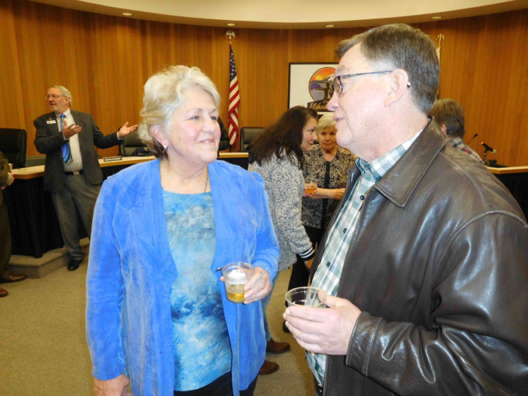 Molly Coston (left) talks to former Washougal city attorney Don English after Coston&#039;s mayoral swearing-in ceremony on Dec. 28, 2017.