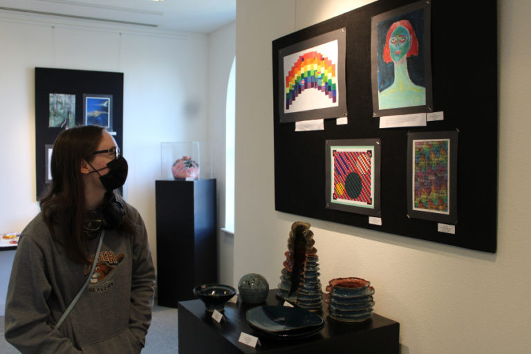 Hayes Freedom High School student Amy Eckert, 17, stands near her colorful, geometric &quot;Textured Rainbow&quot; artwork in colored pencils and India ink during the opening night of the &quot;Stepping Out&quot; youth art show at the Second Story Gallery, located on the second floor of the Camas Public Library in downtown Camas, on Friday, July 1, 2022.