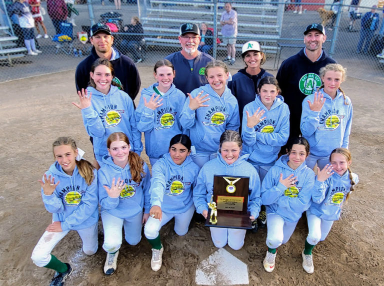 The Camas-based Greenberry Lady A&#039;s 12UB club softball team&#039;s players and coaches show off their championship trophy and championship rings after winning the 2022 USA Softball of Washington state tournament, held July 1-3, 2022, at the Salmon Creek Sports Association Complex in Vancouver.