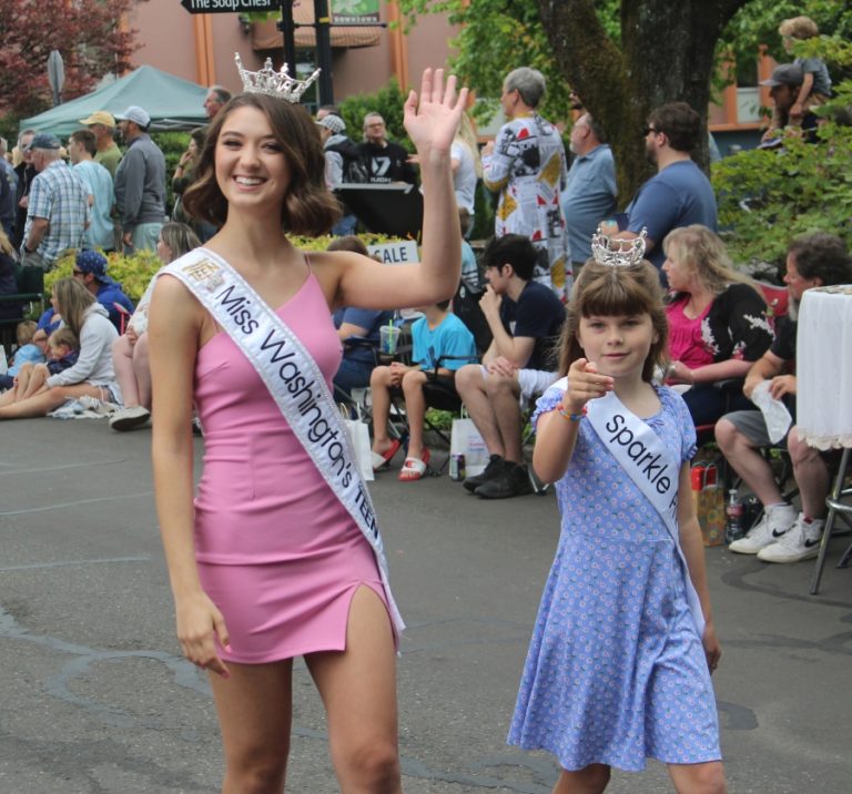 Camas High School student Morgan Greco (left), the winner of the 2022 Miss Washington Outstanding Teen competition, waves to spectators while marching down Fourth Avenue in downtown Camas during the 2022 Camas Days Grand Parade on Saturday, July 23, 2022.