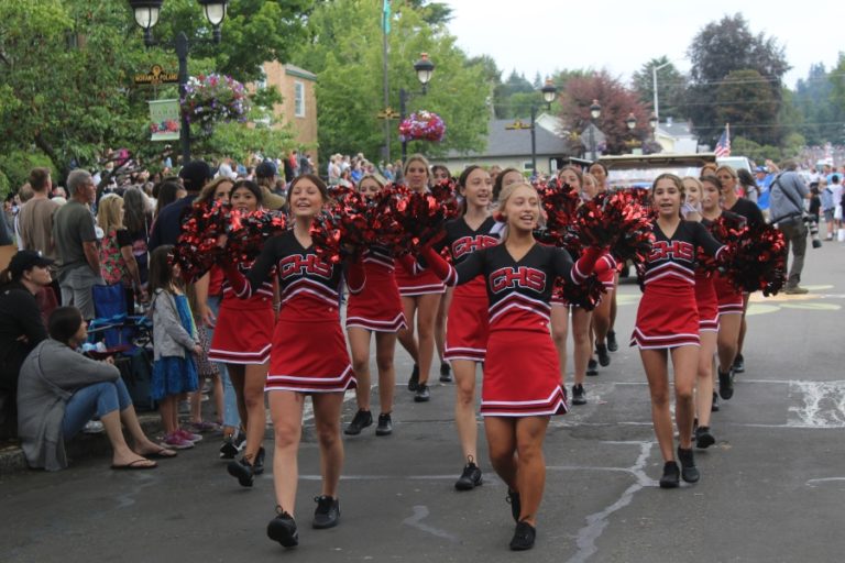 Camas High School cheerleaders march down Fourth Avenue in downtown Camas during the Camas Days Grand Parade Saturday, July 23, 2022.
