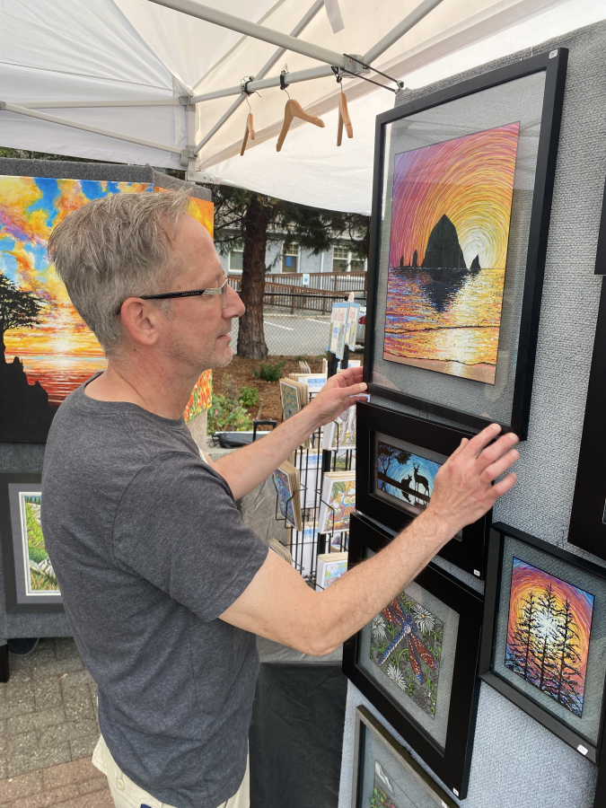 An event-goer appreciates art at the 2021 Washougal Art Festival.
