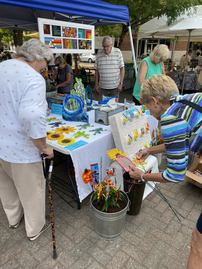 Event-goers look at pieces of art during the 2021 Washougal Art Festival.