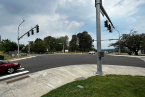 Drivers pass through the intersection at Northwest Brady Road and Northwest 16th Avenue in Camas, near the site of a proposed gas station-convenience store complex known as "Camas Station" on Monday, Aug. 1, 2022. The proposed site (center, vacant parcel with trees) is located near the Prune Hill Sports Park (left), about 300 feet away from Prune Hill Elementary School (not pictured) and across Brady Road from single-family residential developments (not pictured). (Kelly Moyer/Post-Record)