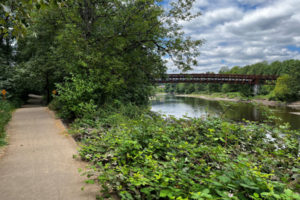 A pedestrian bridge over the Washougal River is seen from the Washougal River Greenway Trail in Camas on Friday, July 22, 2022. Camas officials say the trail and surrounding critical environmental areas are popular sites for individuals experiencing homelessness to set up camp. (Kelly Moyer/Post-Record)