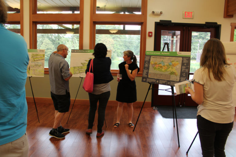 Camas city staff and members of the public view maps showing possible zoning changes in the city's North Shore area, located northeast of Lacamas Lake, during an open house at Lacamas Lake Lodge on Wednesday, Aug. 17, 2022.