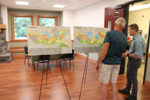 Camas Engineering Manager James Carothers (right) discusses maps showing possible zoning changes in the city's North Shore area, located northeast of Lacamas Lake, during an open house at Lacamas Lake Lodge on Wednesday, Aug. 17, 2022. (Kelly Moyer/Post-Record)