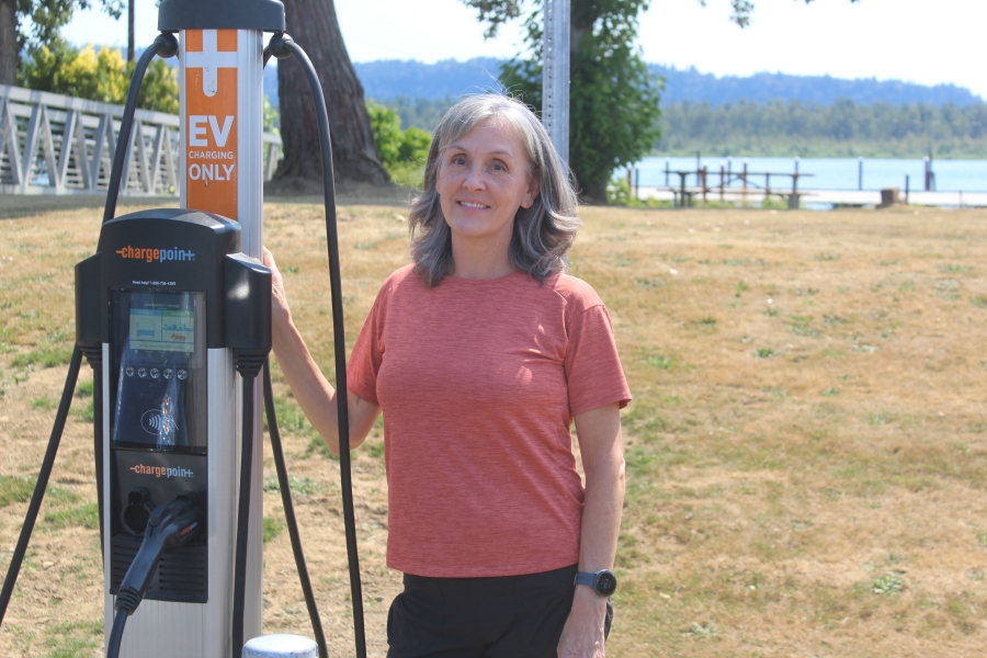 Port of Camas-Washougal Commissioner Cassi Marshall stands next to the Port's new electric vehicle charging station on Friday, Aug. 19, 2022.
