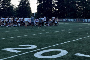 Camas High School football players listen to their coaches after a practice at Cardon Field, behind Camas High, on Monday, Aug. 29, 2022. The Papermakers kick off their 2022 football season this week with an away game against Yelm on Friday, Sept. 2, 2022. (Kelly Moyer/Post-Record)