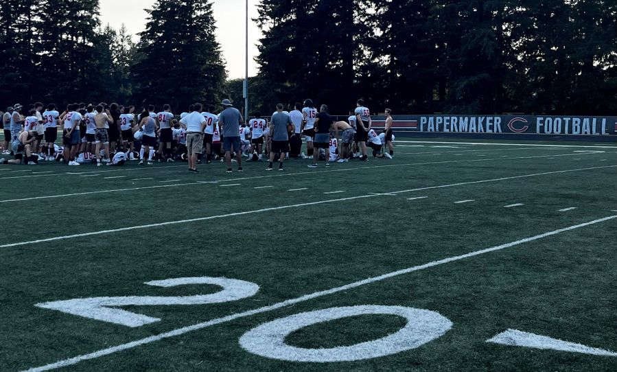Camas High School football players listen to their coaches after a practice at Cardon Field, behind Camas High, on Monday, Aug. 29, 2022. The Papermakers kick off their 2022 football season this week with an away game against Yelm on Friday, Sept. 2, 2022. (Kelly Moyer/Post-Record)