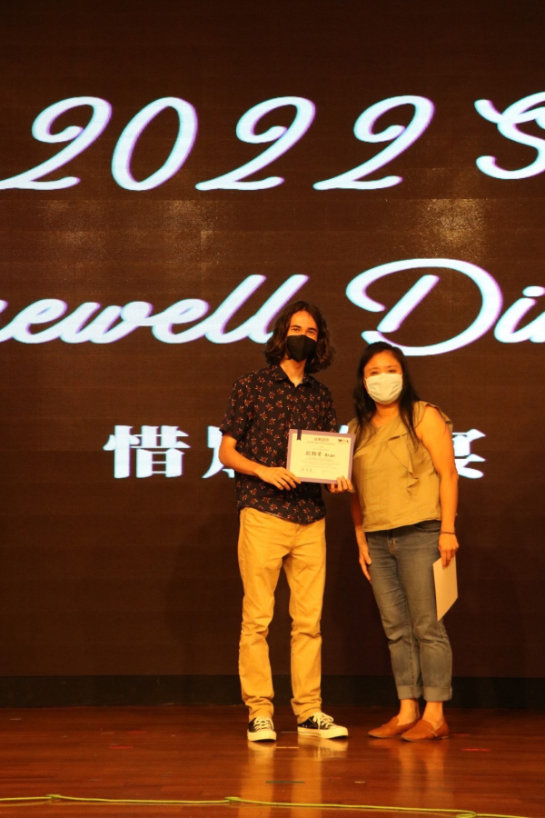 Camas High School senior Aran O'Day (left) accepts a certificate from his Mandarin teacher during a summer study-abroad program in Taiwan in 2022.