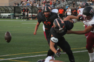 Washougal defesive lineman Sam Basila (52) looks on as teammate Owen Edwards (foreground) forces Toppenish quarterback Joshua Perez to fumble during the first quarter of a non-league game on Sept. 9, 2022, at Fishback Stadium in Washougal. The Wildcats recovered the fumble in their own end zone, leading to a Panthers safety. Toppenish went on to beat Washougal 48-22. (Photos by Doug Flanagan/Post-Record)