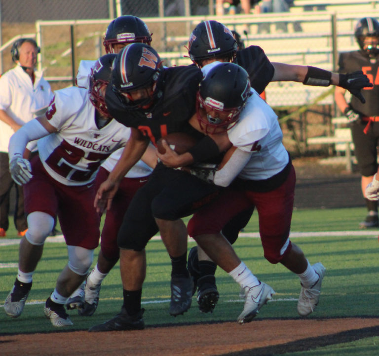 Doug Flanagan/Post-Record 
 Washougal runing back Will Cooper is tackled by Toppenish players during the first quarter of a non-league football game on Friday, Sept. 9, at Fishback Stadium in Washougal.