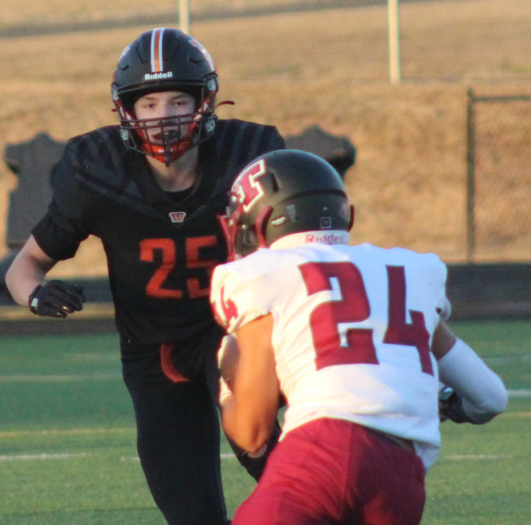 Washougal linebacker Cooper Maxey (25) looks to tackle Toppenish running back Jose Torres during the first quarter of a non-league football game on Friday, Sept.