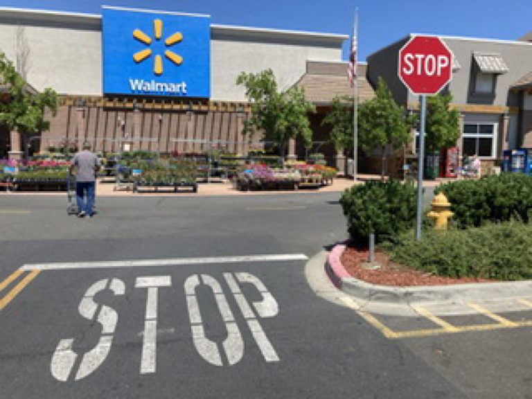 A stop sign sits in front of a Walmart store in Medford, Ore.