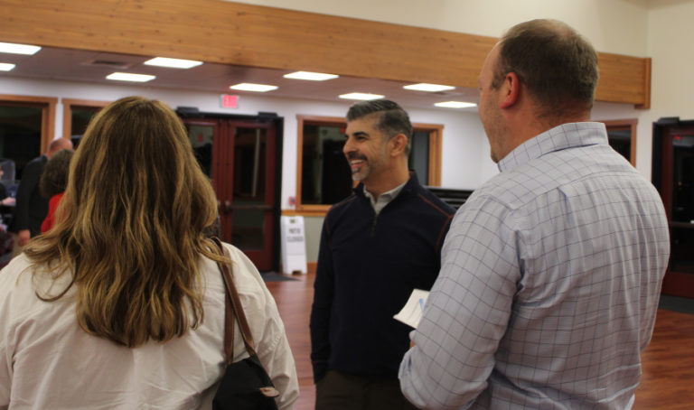 Camas School District Superintendent John Anzalone (center) greets Camas School Board members, including  Erika Cox (left) and Corey McEnry (right), during the 2022 State of the Community event held Thursday, Sept. 15, 2022, at the Lacamas Lake Lodge in Camas.
