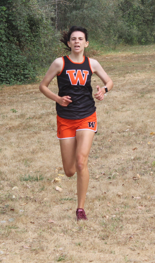 Washougal High School senior runner Sydnee Boothby crosses the finish line to complete a race at William Clark Park on Thursday, Sept. 14, 2022.