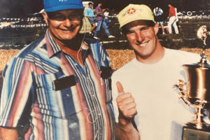 Washougal MX Park owner Ralph Huffman (left) presents racer Mike Kiedrowski with a trophy during a Washougal National race in the 1990s. (Contributed photo courtesy of Ryan Huffman)