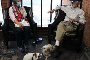 American Red Cross Cascades Region volunteer and retired registered nurse Shirley Toth (left), meets with Nakia Creek Fire evacuee Dwight Daley (right) and his two dogs, Jaxie, 7, (second from left) and Sammy, 8, at the Red Cross' wildfire evacuation shelter inside the Camas Church of the Nazarene on Monday, Oct. 17, 2022. (Kelly Moyer/Post-Record)
