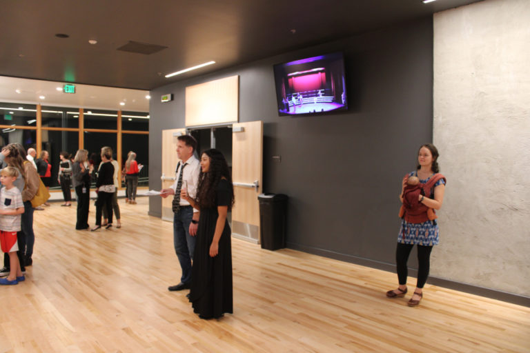 A crowd gathers inside the newly renovated two-story lobby of the Camas School District&#039;s Joyce Garver Theater during the historic theater's reopening event on Wednesday, Oct. 19, 2022.