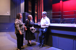 Skyridge Middle School music teachers Mishele Mays (left) and Brenda Sappington (center) talk to Liberty Middle School Band Director Greg Henion (right) inside the Camas School District's newly renovated Joyce Garver Theater -- named for former Camas music teacher Joyce Garver -- during a theater-reopening event on Wednesday, Oct. 19, 2022. (Kelly Moyer/Post-Record)