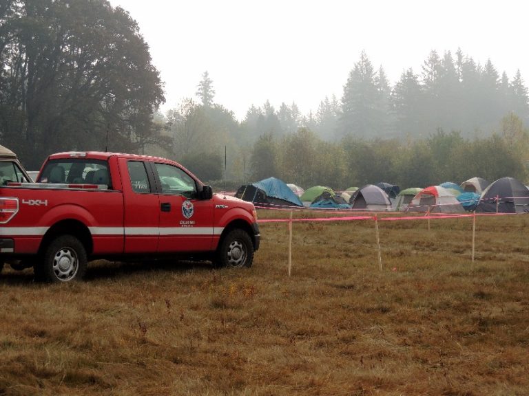 Officials set up camp for firefighters in a field across from Grove Field in Camas.