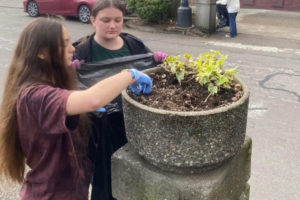 Members of the Washougal-based Girl Scout Troop 45703 collect debris in downtown Camas during a downtown cleanup event in 2022.