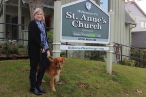 Vicar Annie Calhoun poses for a photograph with her golden retriever, Buddy, outside of St. Anne's Church in Washougal on Tuesday, Nov. 8, 2022. (Doug Flanagan/Post-Record)