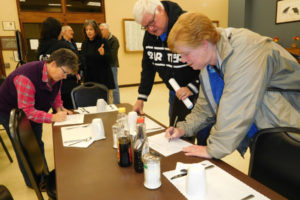 Michelle Wolcott (left), Rick Jones (center) and Patty Buslach (right), all of Washougal, sign up to volunteer at a severe weather shelter in downtown Washougal, after attending a Nov. 29, 2018, informational meeting. (Post-Record files)